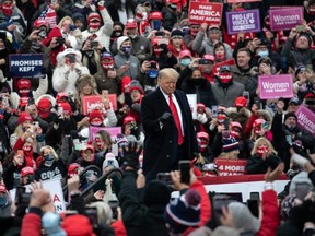 U.S. President Donald Trump greets supporters at a campaign rally at Oakland County International Airport in Waterford, Michigan, Friday, Oct. 30, 2020.