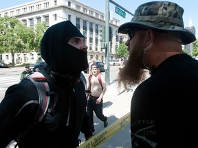 An Antifa demonstrator has a heated exchange with a pro-Trump supporter during the Denver March Against Sharia Law in Denver, Colorado on June 10, 2017.
