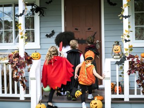 Young kids going trick-or-treating at Halloween.