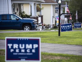 In this file photo, "Trump-Pence" signs and banners are seen on a street in Olyphant, just outside Scranton, Pa., on Aug. 11, 2020.