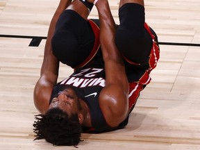 Jimmy Butler of the Miami Heat reacts after rolling his ankle during Game 1 of  The Finals against the Los Angeles Lakers at the ESPN Wide World Of Sports Complex on Wednesday night in Lake Buena Vista, Fla. Butler plans to play through the pain in Game 2.