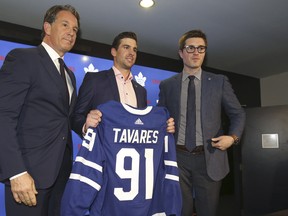 Toronto Maple Leafs president Brendan Shannon (L) and general manager Kyle Dubas (R) pose with  John Tavares who signed a seven-year $77 million on NHL Free Agency day on Sunday July 1, 2018. Jack Boland/Toronto Sun