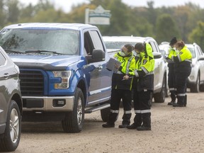 Middlesex-London paramedics interview motorists as they wait to be tested at a COVID-19 testing centre at the Dorchester Outdoor Recreation Centre on Wednesday, September 30, 2020.