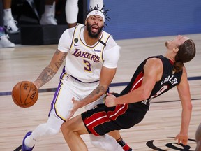 Anthony Davis of the Los Angeles Lakers is called for a foul against Kelly Olynyk of the Miami Heat during the first half in Game Three of the 2020 NBA Finals on Oct. 4, 2020, in Lake Buena Vista, Fla.