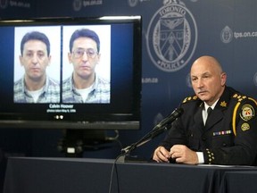 Toronto Police Chief James Ramer sits next to a screen displaying photos of Calvin Hoover during a news conference at Toronto Police Headquarters, Thursday, Oct. 15, 2020. Ramer said DNA evidence indicated Calvin Hoover, then 28, who was known to the girl's family, had sexually assaulted Christine Jessop.