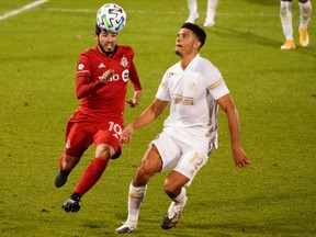 Toronto FC's Alejandro Pozuelo (10) works for the ball against Atlanta United defender Miles Robinson earlier this month.