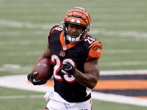 Joe Mixon of the Cincinnati Bengals runs for one of his three touchdowns during his team's 33-25 win against the Jacksonville Jaguars on Oct. 4, 2020 in Cincinnati.