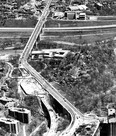 This interesting aerial view from the Toronto Telegram collection was taken in 1964 and looks east across the Don and Rosedale Valleys and highlights the construction of the Bloor-Danforth subway and the TTC's Castle Frank Station. Note the covered section of the subway tracks at the bottom of the photo designed to keep subway noises from disturbing those living nearby. The first section of the subway opened in late February 1966. Visible are the two bridge sections of the Viaduct (top Don Valley Bridge, bottom Rosedale Valley Bridge). Parliament St. is at the bottom of the view. Also visible are the right-of-way of the future Don Valley Parkway, the Don River and Rosedale Valley Rd. The sprawling structure in the centre of the view is the Rosedale Heights School of the Arts.