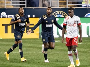 Philadelphia Union defender Mark McKenzie (centre) reacts in front of defender Ray Gaddis and TFC midfielder Richie Laryea after scoring during the first half at Subaru Park. USA TODAY