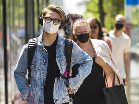 Riders leave a TTC streetcar on Spadina Ave., at at Queen St. W. in Toronto, Ont. on Thursday July 2, 2020.  Starting today, with certain exceptions, masks or face coverings are mandatory when travelling on the TTC. Ernest Doroszuk/Toronto Sun/Postmedia