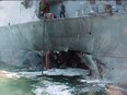 This handout file photo taken Oct. 12, 2000 shows the port side of the guided missile destroyer USS Cole damaged after a suspected terrorist bomb exploded during a refuelling operation in the port of Aden in Yemen.
