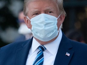 In this file photo taken on October 05, 2020 US President Donald Trump leaves Walter Reed Medical Center in Bethesda, Maryland heading to Marine One, to return to the White House after being discharged.