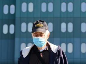 A man wearing a face mask walks outside the Dubrava Clinical Hospital in Zagreb on October 19, 2020.