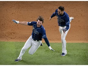 Oct 24, 2020; Arlington, Texas, USA; The Tampa Bay Rays center fielder Kevin Kiermaier (39) and right fielder Brett Phillips (14) celebrate Phillips hitting the game winning two run walk off single against the Los Angeles Dodgers during the ninth inning in game four of the 2020 World Series at Globe Life Field. Mandatory Credit: Jerome Miron-USA TODAY Sports ORG XMIT: IMAGN-431119