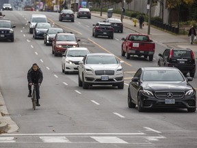 A cyclist is seen riding along Yonge St., south of Lawrence Ave. -- where Toronto City Council has approved a plan for temporary protected bike lanes established along Yonge St. from Bloor St. to Lawrence Ave. -- on Thursday, Oct. 29, 2020.