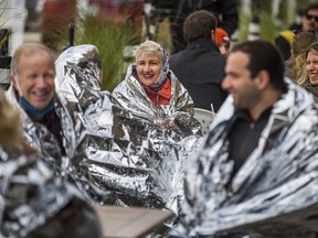 Toronto Councillor Paula Fletcher joins others wrapped in thermal blankets after launching the Broadview Danforth BIA's "Fall Thrill of the Chill Program" on the patio of the Dora Keogh Irish Pub on Danforth Ave. on Saturday, Oct. 24, 2020.
