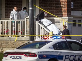 A body is removed while Peel Regional Police are at the scene on Yately St. in Brampton after a fatal shooting on Monday, October 5, 2020.
