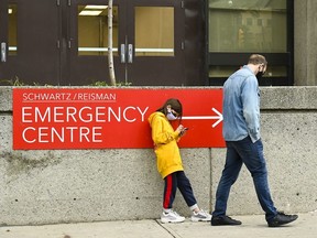 People wait in line for hours at a COVID assessment centre at Mount Sinai Hospital during the COVID-19 pandemic in Toronto on Thursday, September 24, 2020.