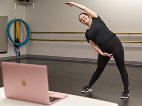 Taylor Flinders, an instructor and senior student at Studio 5678 in Brantford, Ont., records a stretching and technique video that is posted on the studio's private YouTube channel, May 21, 2020.