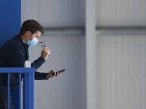 Maple Leafs general manager Kyle Dubas reads his phone during NHL training camp ahead of the NHL Stanley Cup playoffs in Toronto on Wednesday, July 15, 2020