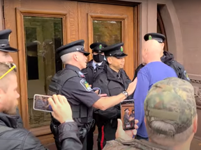 A man believed to be Brian Kidder, 60, was arrested and charged with two counts of assaulting a peace officer after allegedly attempting to force his way into the Legislature building during an anti-mask rally on Oct. 21, 2020.