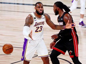 Los Angeles Lakers forward LeBron James, left, reacts after a call during the fourth quarter of Game 3 of the 2020 NBA Finals against the Miami Heat at AdventHealth Arena, in Orlando, Fla., Oct. 4, 2020.