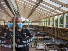 Rick Hugglestone, owner of Mulligan's Pub in Mississauga, has installed a temporary roof to cover the patio and dividers to separate tables in order to keep customers safe and comfortable while dining outside amid pandemic restrictions.