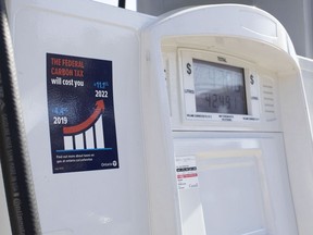 A gas pump displays an anti-carbon tax sticker in Toronto on Thursday, August 29, 2019.