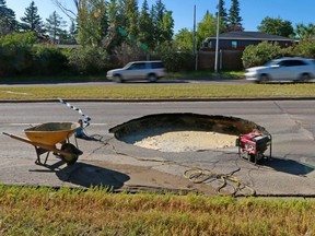 A large sinkhole appears in the westbound lanes of Southland Drive in Calgary, Aug. 5, 2020.