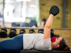 Rachel Aitken works out at Hone Fitness after indoor dining restaurants, gyms and cinemas re-opened under Phase 3 rules from COVID-19 restrictions in Toronto, July 31, 2020.