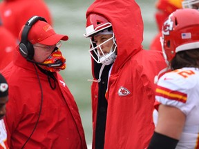 Kansas City Chiefs head coach Andy Reid speaks to quarterback Patrick Mahomes.