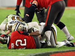 Saints defenders Trey Hendrickson (left) and Cameron Jordan sack Tampa Bay's Tom Brady on Sunday.