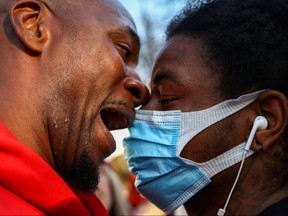 A counter-demonstrator and supporter of U.S. President Donald Trump clashes with a protester during an anti-Trump rally in the aftermath of the 2020 U.S. presidential election, at Black Lives Matter Plaza in Washington, D.C., Nov. 13, 2020.