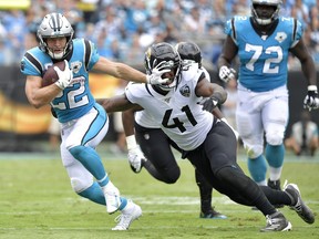Panthers’ running back Christian McCaffrey stiff-arms Jaguars’ Josh Allen. McCaffrey will miss this week’s game after injuring his shoulder against the Chiefs in Week 9.