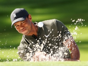 Tiger Woods plays a shot from the bunker on the second hole during the first round of the Masters at Augusta National Golf Club. Woods was four under on the day.