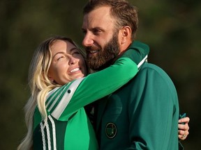 Dustin Johnson of the United States celebrates with fiancée Paulina Gretzky during the Green Jacket Ceremony after winning the Masters at Augusta National Golf Club on November 15, 2020 in Augusta, Georgia.