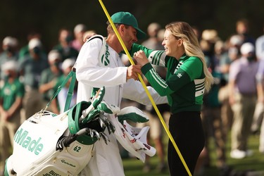 Paulina Gretzky, fiancée of Dustin Johnson of the United States (not pictured), celebrates with caddie Austin Johnson on the 18th green after Dustin Johnson won the Masters at Augusta National Golf Club on November 15, 2020 in Augusta, Georgia.