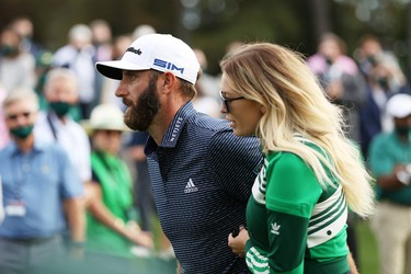 Dustin Johnson of the United States walks with fiancée Paulina Gretzky after winning the Masters at Augusta National Golf Club on November 15, 2020 in Augusta, Georgia.