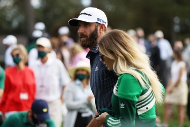 Dustin Johnson of the United States walks with fiancée Paulina Gretzky after winning the Masters at Augusta National Golf Club on November 15, 2020 in Augusta, Georgia.