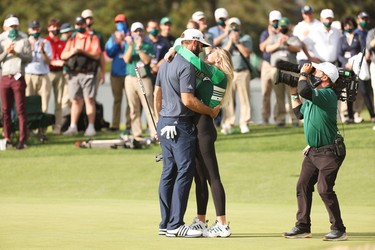 Dustin Johnson of the United States kisses fiancée Paulina Gretzky after winning the Masters at Augusta National Golf Club on November 15, 2020 in Augusta, Georgia.