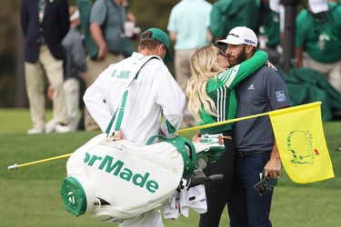 Dustin Johnson of the United States kisses fiancée Paulina Gretzky after winning the Masters at Augusta National Golf Club on November 15, 2020 in Augusta, Georgia.