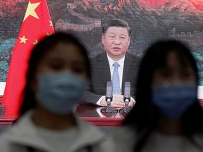 China's President Xi Jinping is seen on a screen in a media centre as he speaks at the opening ceremony of the third China International Import Expo (CIIE) in Shanghai, China on Nov. 4, 2020.