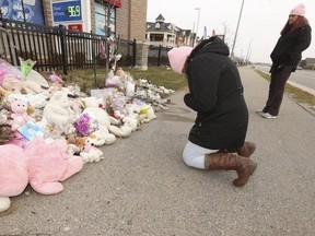 Jillian McLeod (R), from Justice 4 Families, and her friend, Beata Cioncka (L), wear pink commemorative tuques on the five-month anniversary of the fatal-collision deaths of Karolina Ciasullo and her little daughters Klara, 6, Lilianna, 3 and Mila.