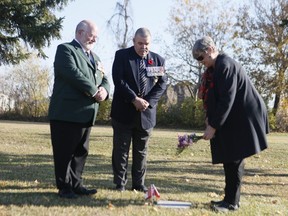 Capt. Brain Patterson,(L) Shirley Elms and Col. Geordie Elms are pictured in Etobicoke at a once-forgotten grave of a Canadian veteran of the First World War on Nov. 8, 2020.