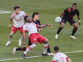 Toronto FC forward Ayo Akinola (20) battles New York Red Bulls midfielder Aaron Long (33) for the ball during the first half at Red Bull Arena.
