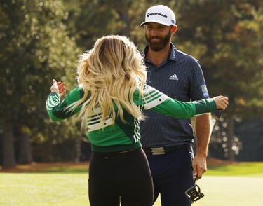 Dustin Johnson of the U.S. celebrates with partner Paulina Gretzky on the 18th green after winning The Masters.