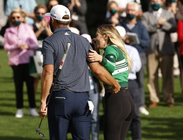 Dustin Johnson of the U.S. celebrates with partner Paulina Gretzky on the 18th green after winning The Masters.