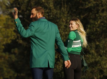 Dustin Johnson of the U.S. celebrates with his green jacket and partner Paulina Gretzky after winning The Masters.