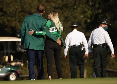 Dustin Johnson of the U.S. celebrates with his green jacket and partner Paulina Gretzky after winning The Masters.