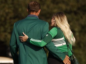 Well before he received the coveted Green Jacket from Tiger Woods, Dustin Johnson received something even more special -- a kiss from Paulina Gretzky.
